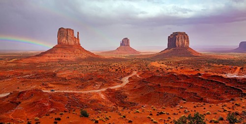 USA. Navajo Indian Reservations. The famous rock Mitten and the bright rainbow. Monument Valley is