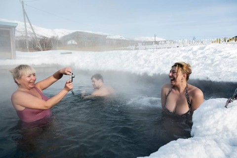 KAMCHATKA PENINSULA, RUSSIA, FEB 02, 2013: Two joyful women photographed while swimming in