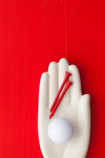 Detail of artifical hand with golf equipments - Flat Lay Photography