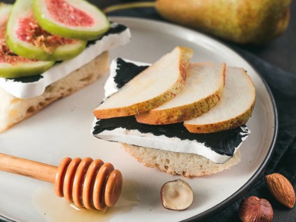 Toast with black camembert cheese and pears slices on plate. Healthy snack or breakfast idea and