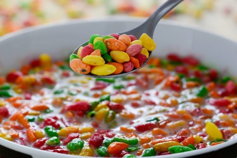 Prepared breakfast with colorful puffed rice with spilled rice in the background