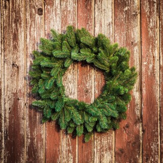 Christmas wreath on the shabby wooden door. Christmas holiday background with copy space
