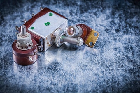 Electric toggle switch lamp-holder on metallic surface electricity concept