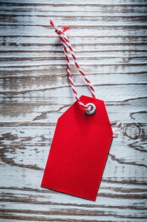 Red pricetag on vintage wooden board shopping concept
