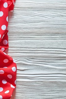 Red cotton polka-dot textile on wooden board