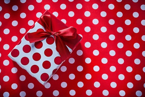 Wrapped box with present on polka-dot fabric celebrations concept