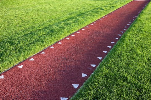 Running track with a red sysnthetic surface for a long jump competition