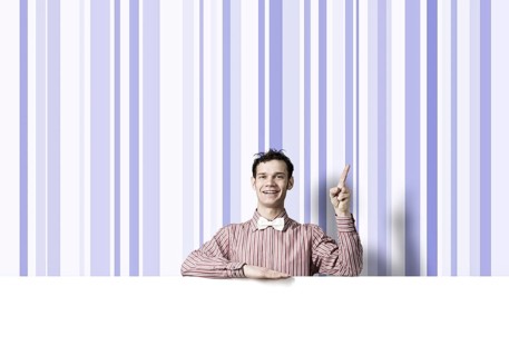Young funny guy in checked shirt with banner pointing with finger up