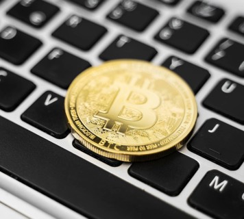 Golden bitcoin coin cryptocurrency on the laptop keyboard