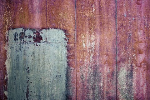Rusty iron sheet with corrosion, selective focus, textured background