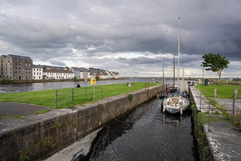 Boat anchored in Eglinton Canal Sea Lock, The Long Walk, Galway, Ireland, United Kingdom