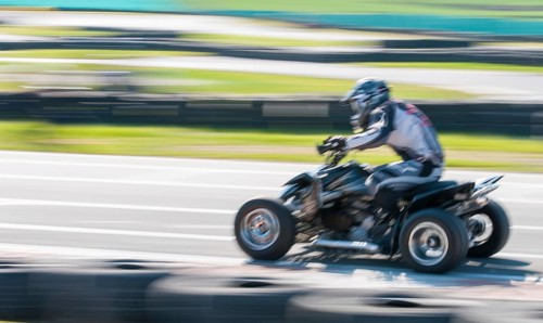 Unrecognised man is driving Go-kart with speed in the on a karting track