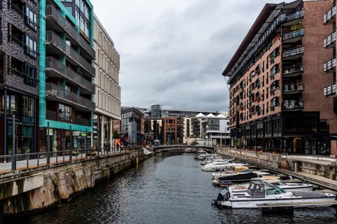 Oslo, Norway, August 11, 2019: Canal with boats in Tjuvholmen quarter, a new modern urban renewal