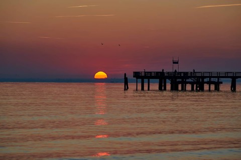 Sunrise over the sea at the pier of the Baltic Sea resort, Boltenhagen, Mecklenburg-Vorpommern,