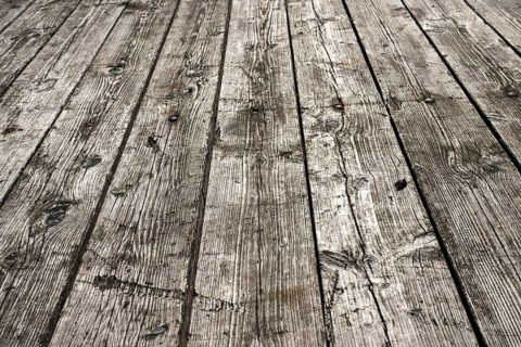 Weathered gray wooden floorboards as background photo
