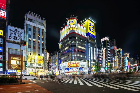TOKYO, JAPAN, SEPTEMBER 16 2024: Neon signs illuminate with traffic in Tokyo's busy Shinjuku