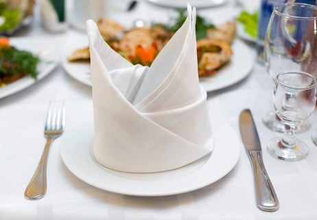 Place setting at laid restaurant banquet table