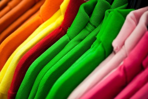 Colorful t-shirts hanging on a rack