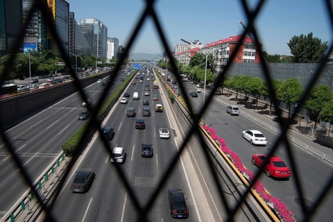 Beijing, China ? June 4 2019: Cars moving fast on a busy multi lane highway in city of Beijing in