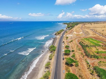 Aerial view of beach and ocean with waves in the island of Maui, Hawaii. Launiupoko State Beach