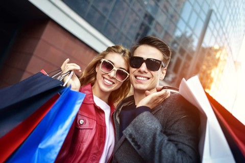 Portrait of a couple with shopping bags in the city.People, sale, love and happiness concept