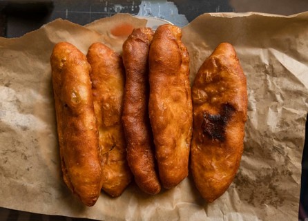 Fried pies lie on craft paper on the table