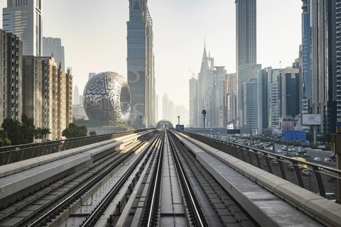 Dubai, UAE - 11.3.2022: Dubai Metro rail with skyscrapers and Museum of the Future in Dubai in the