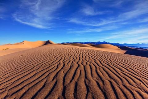 Thin waves on sand. Bright solar morning in picturesque part of Death Valley, USA. Mesquite Flat