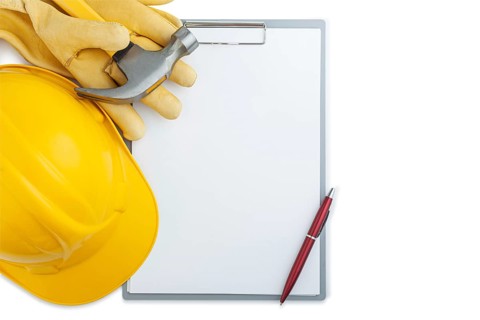 Helmet Yellow construction Gloves Claw Hammer On Clipboard Isolated