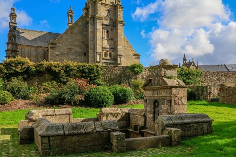 Enclosed parish Gothic church Eglise Saint-Gouesnou and spring of the same name, Gouesnou near