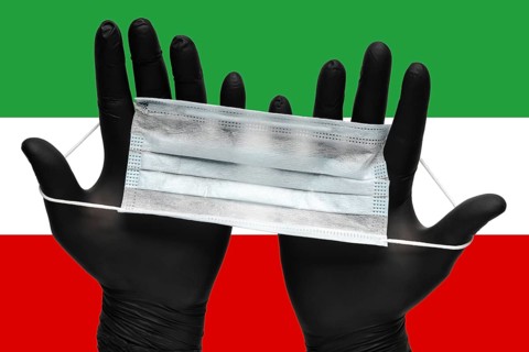 Doctor holds respiratory face mask in hands in black medical gloves on background colors flag of
