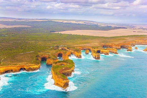 Aerial view. Helicopter flight over the scenic Pacific coastline. Australia. The Twelve Apostles