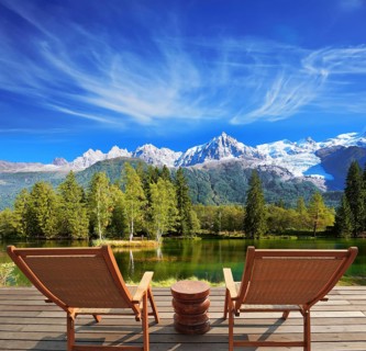 City park in the Alpine resort. Comfortable lounge chairs on wooden platform for rest and