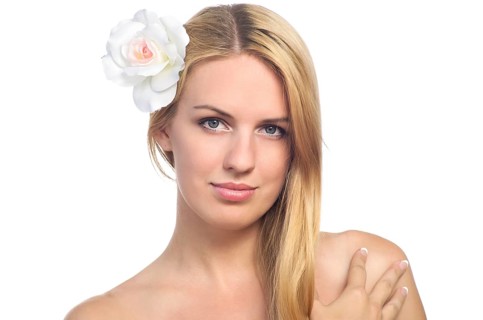 Portrait of beautiful woman with healthy skin with flower in her hair. Isolated on white background