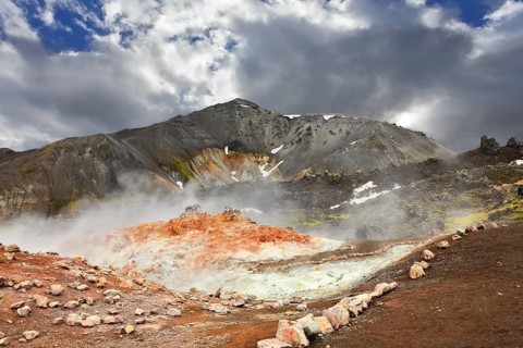 Rhyolite mountains smoldering underground heat. In the hollows lie unmelted snow patches from last