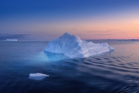 Floating glaciers in the rays of the setting sun at polar night