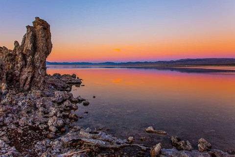 Magic sunset on the lake. Lime-tuff towers of bizarre shapes rise from the bottom of the lake. The