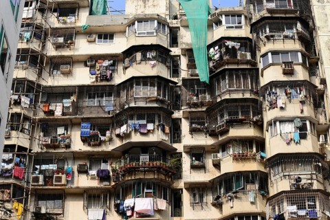 High-rise building with numerous rounded balconies and hanging laundry, Aurangabad, Mumbai, South
