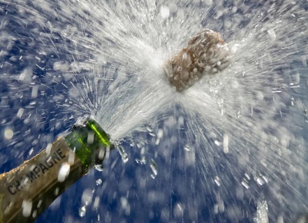 Popping cork of an opened champagne bottle