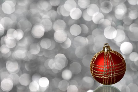 Red Christmas ball on silver blurred background