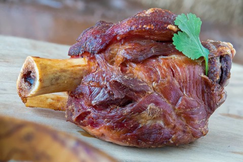 Grilled pork knuckle on a wooden board