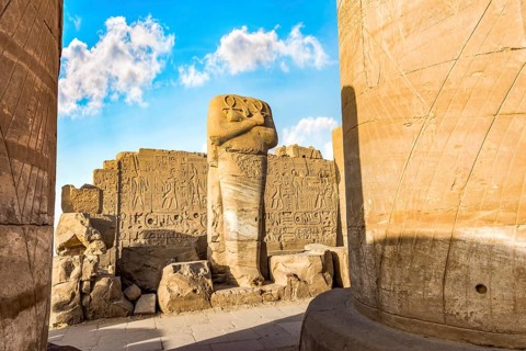 Headless statue among the ruins in Karnak Temple, Luxor