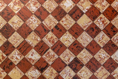 Old-fashioned antique brown beige floor tiles in a characteristic old farmhouse in the Netherlands