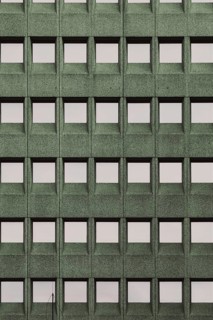 Building facade with a green grid pattern and square windows, in Rotterdam, South Holland,