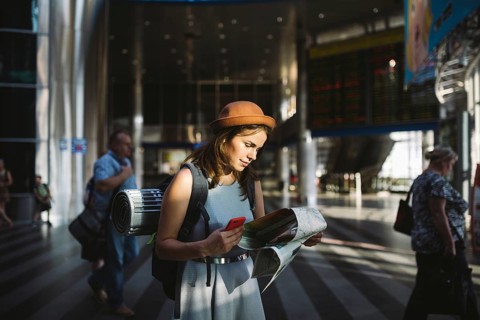 Theme travel and transportation. Beautiful young caucasian woman in dress and backpack standing