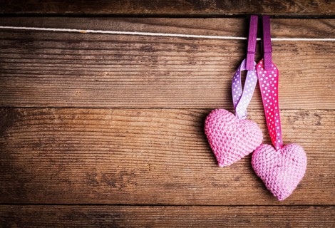 Crochet valentine hearts handing on the rope. Valentine's day greeting card. Love concept