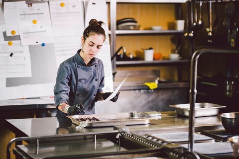 Subject profession and cooking pastry. young Caucasian woman with tattoo of pastry chef in kitchen