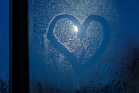 Moonlight through the window. Sweaty glass and heart shape