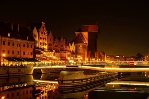 Old town in Gdansk at night. The riverside on Granary Island reflection in Moltawa River Cityscape