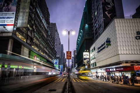 HONG KONG, CHINA - SEPTEMBER 28, 2024: Busy Nathan Rd at night with famous signage, architecture